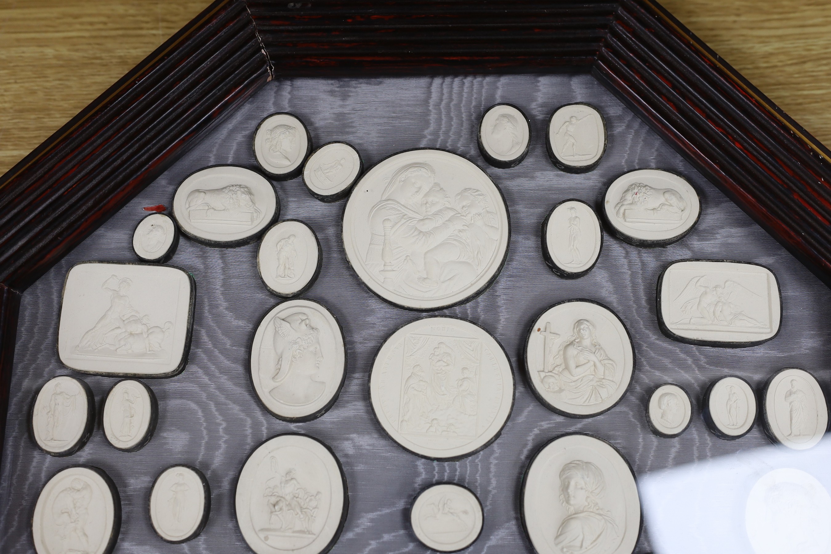 After the antique, a pair of octagonal framed grand tour plaster plaques, 44 x 44cm total